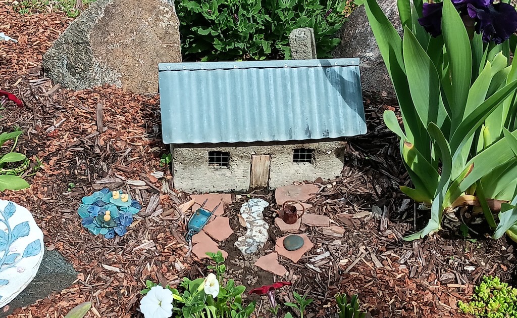 A truly tiny house model in a garden